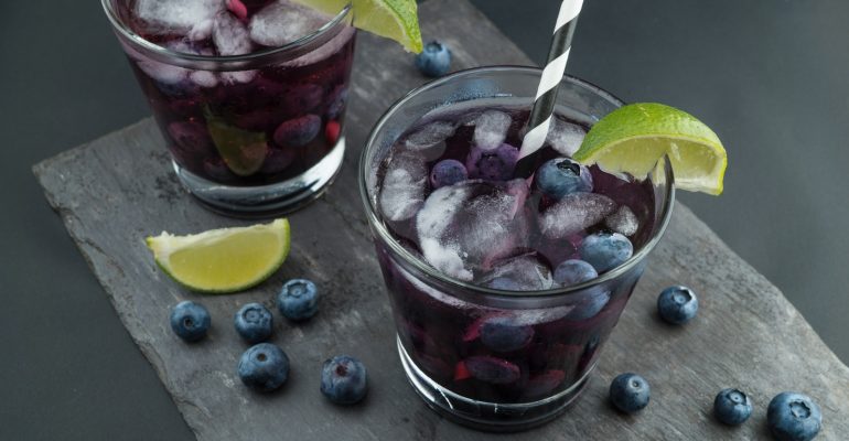 rock glasses surrounded by blackberries