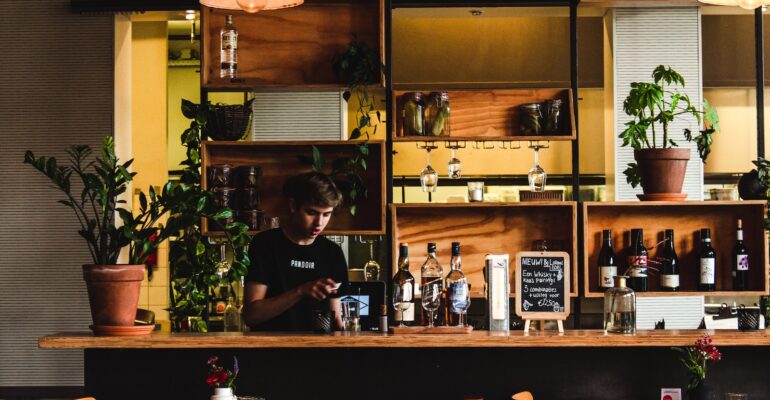 man standing in front of bar table
