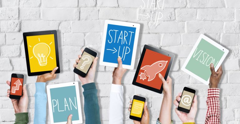 Group,Of,Hands,Holding,Digital,Devices,With,Startup,Concept