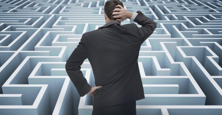 Back of businessman getting lost in a maze